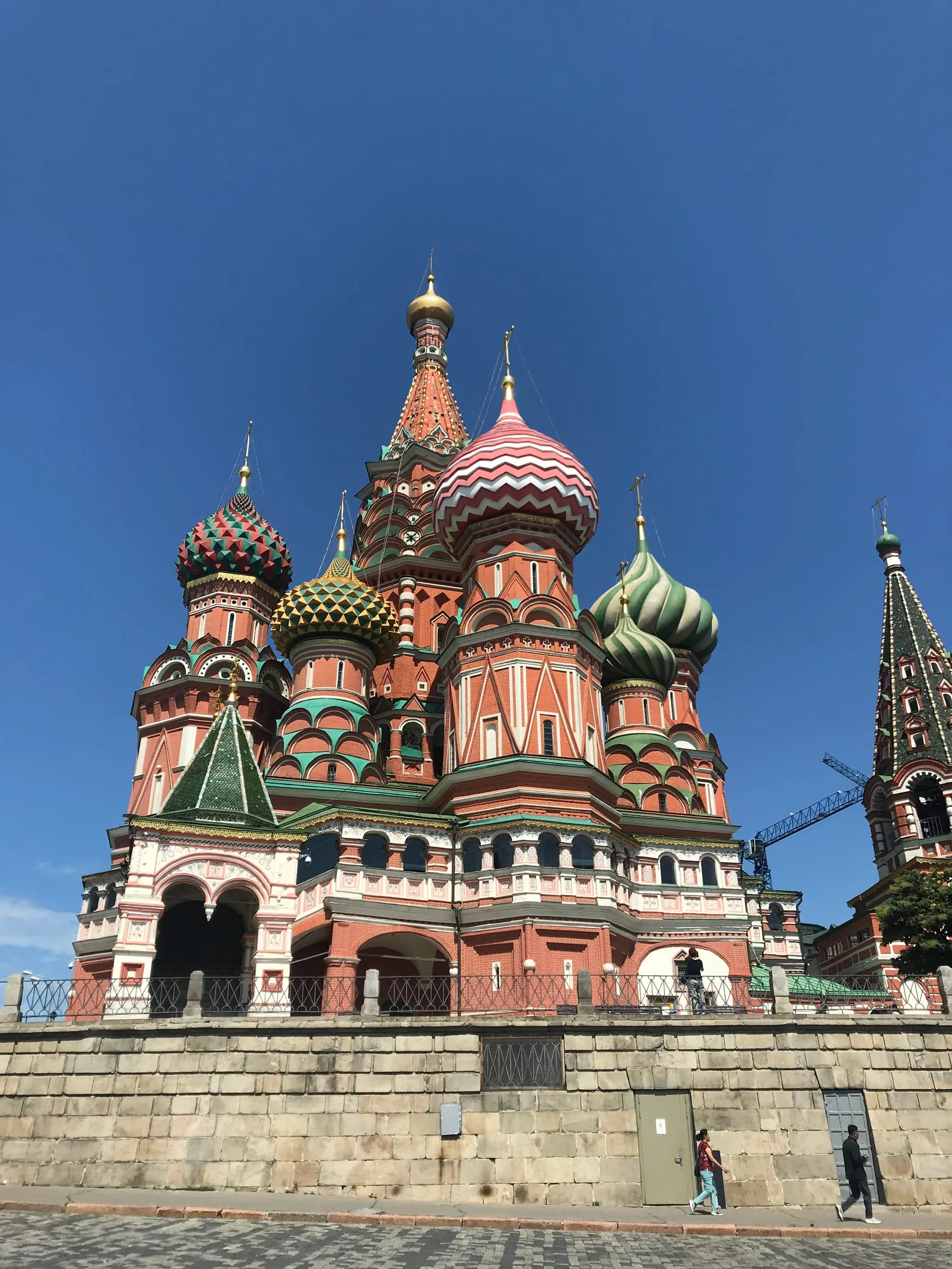 The coloured onion domes of St Basil's Cathedral against a deep blue sky