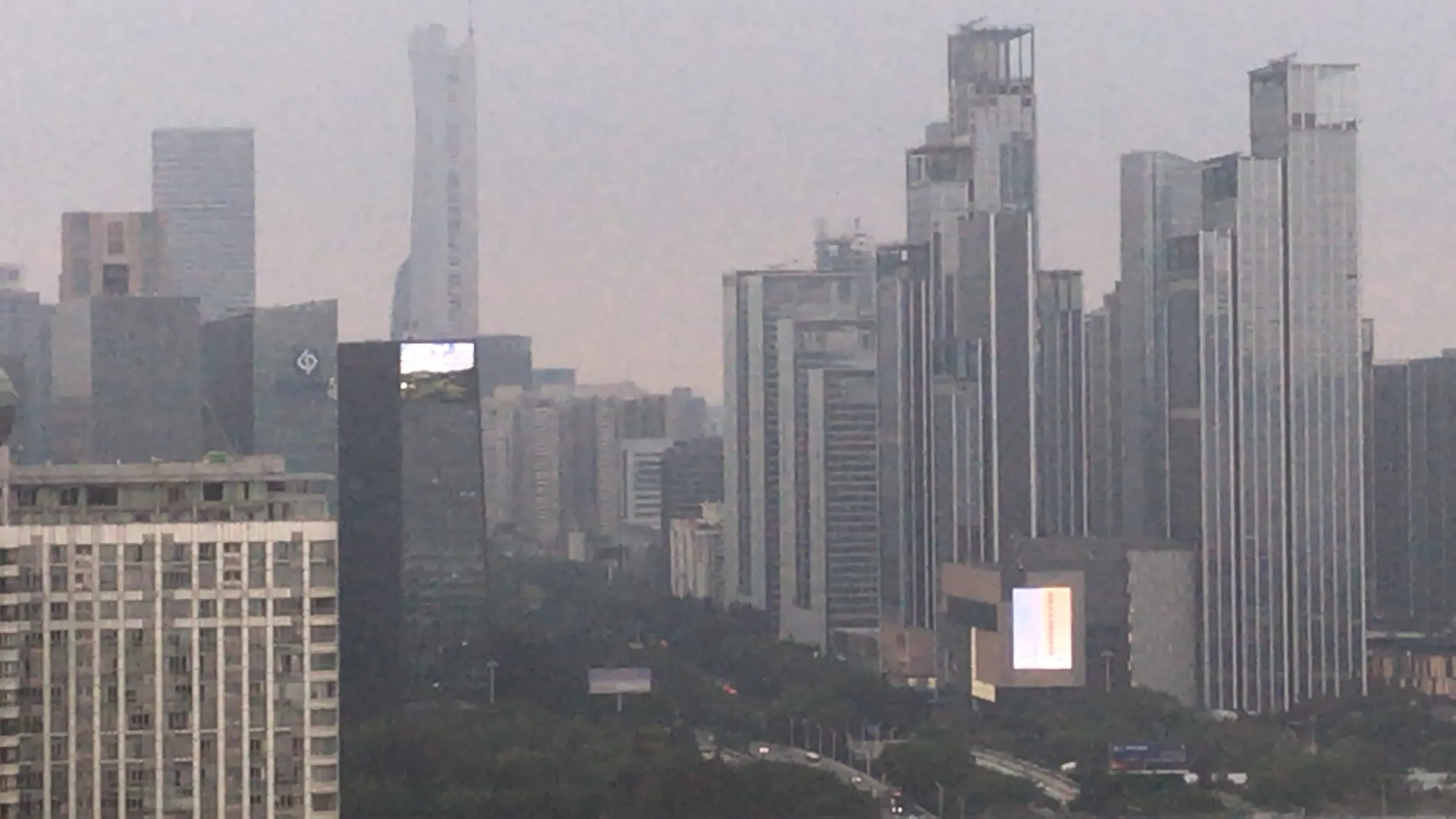 Tall office towers fading into an evening haze
